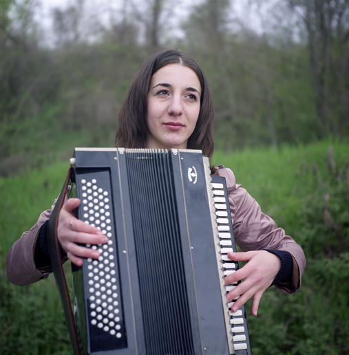 Svetlana, member of a Circassian folk troupe, with an accordion. ASHE/SOCHI, RUSSIA, MAY 2009