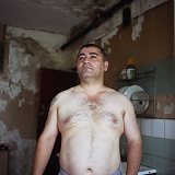RUSSIA / St.Petersburg / July 2007 / A migrant worker from Azerbaijan who refused to give his name poses for picture in a dilapidated communal kitchen.   

© Max Sher / Anzenberger