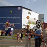 RUSSIA / Magnitogorsk / July 2008 / People gathering at a funfair on the occasion of the Metal-Makers' Day, a popular local holiday. The Arena-Metallurg ice hockey stadium is in the background.    

© Max Sher / Anzenberger